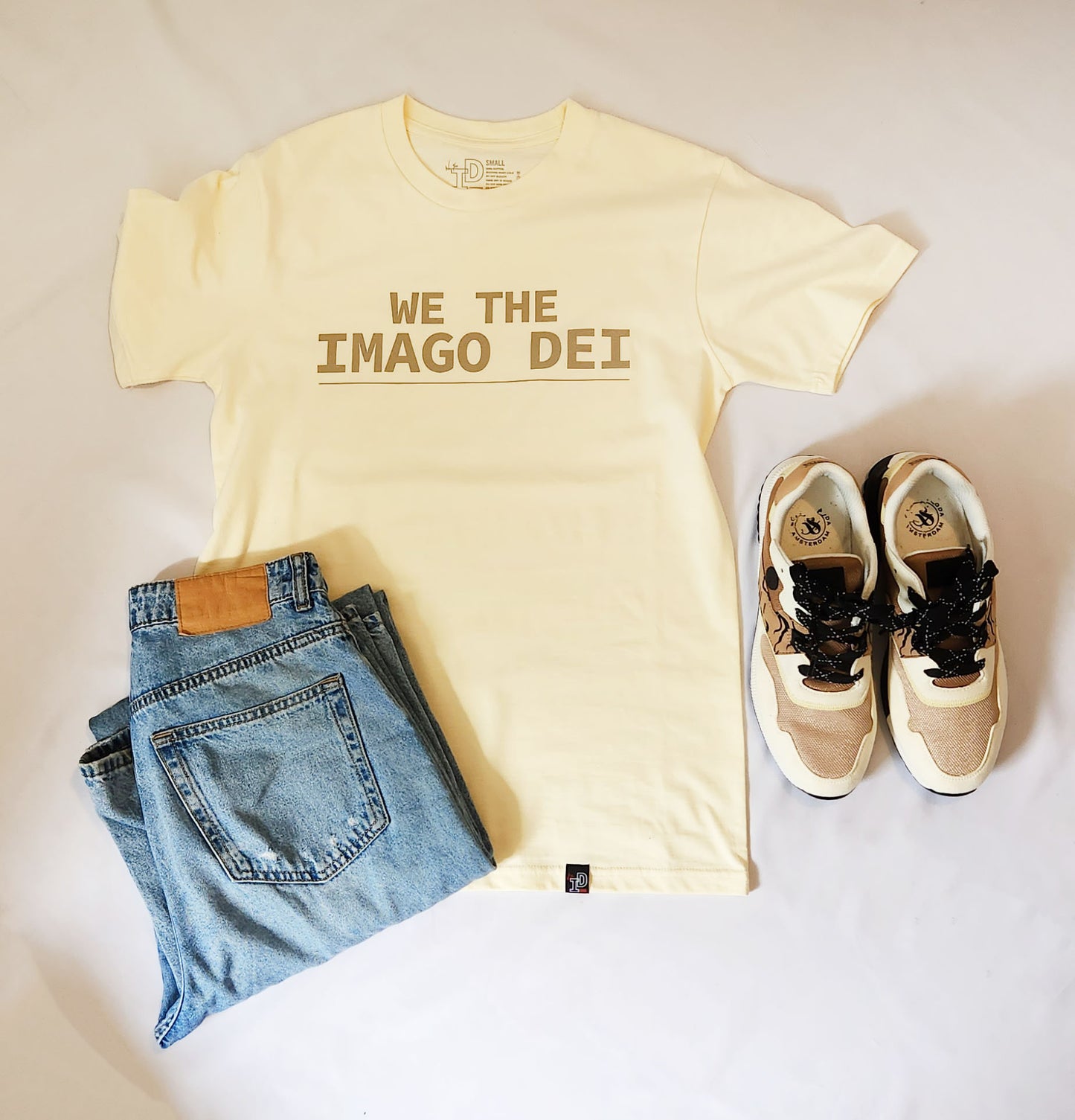 butter tee flatlay with jeans and denim